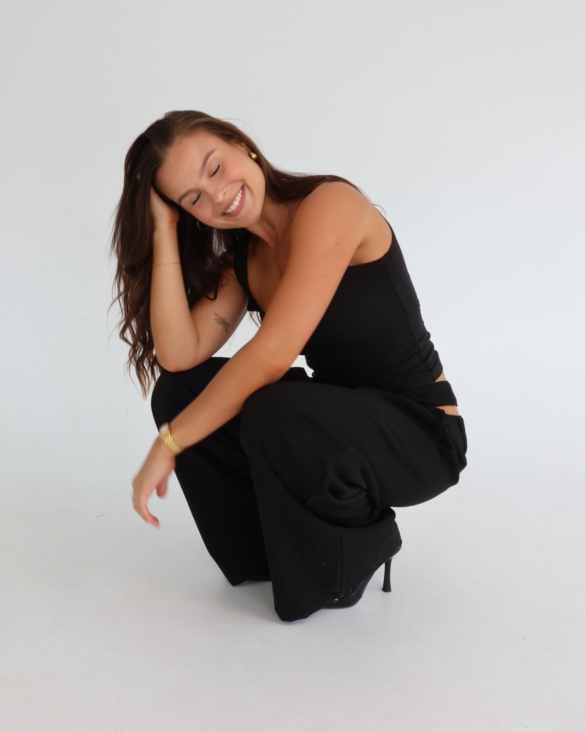 G crouching and smiling